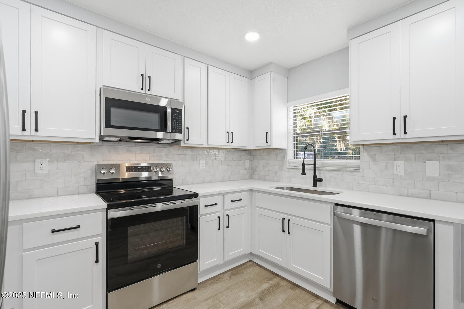 341 Alabama Avenue Palatka, FL 32177 - Photo 19 of 47 a kitchen with cabinets stainless steel appliances a sink and a window