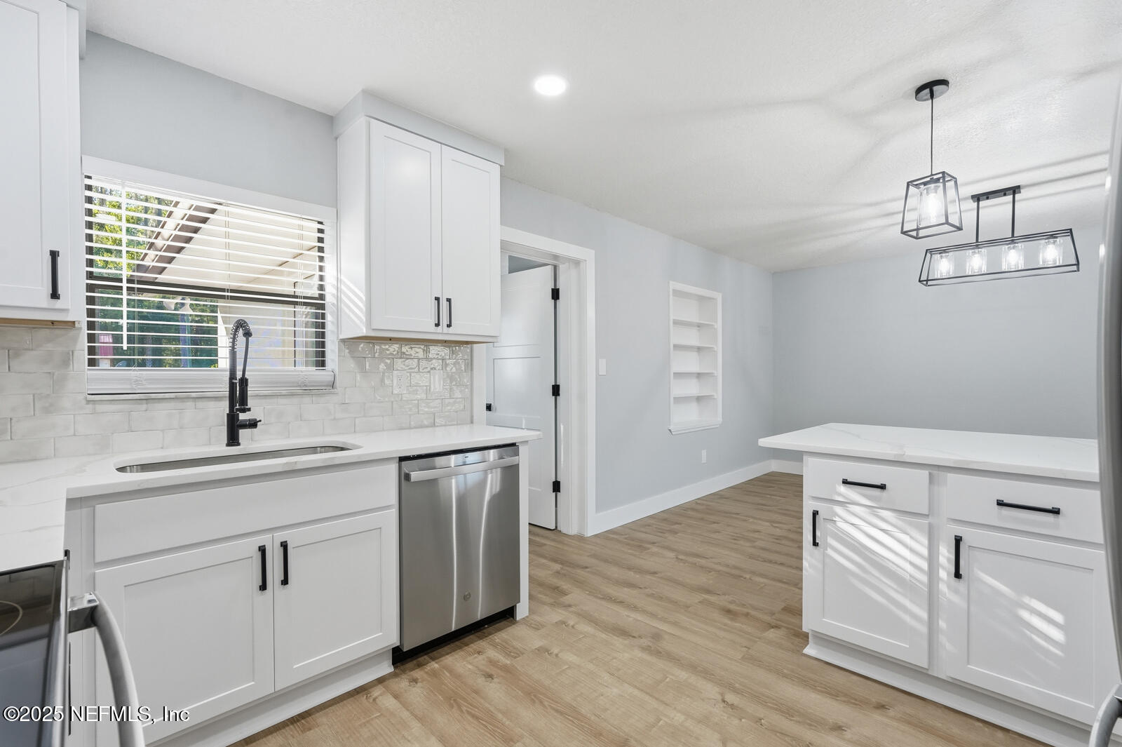 341 Alabama Avenue Palatka, FL 32177 - Photo 20 of 47 a kitchen with white cabinets and white appliances