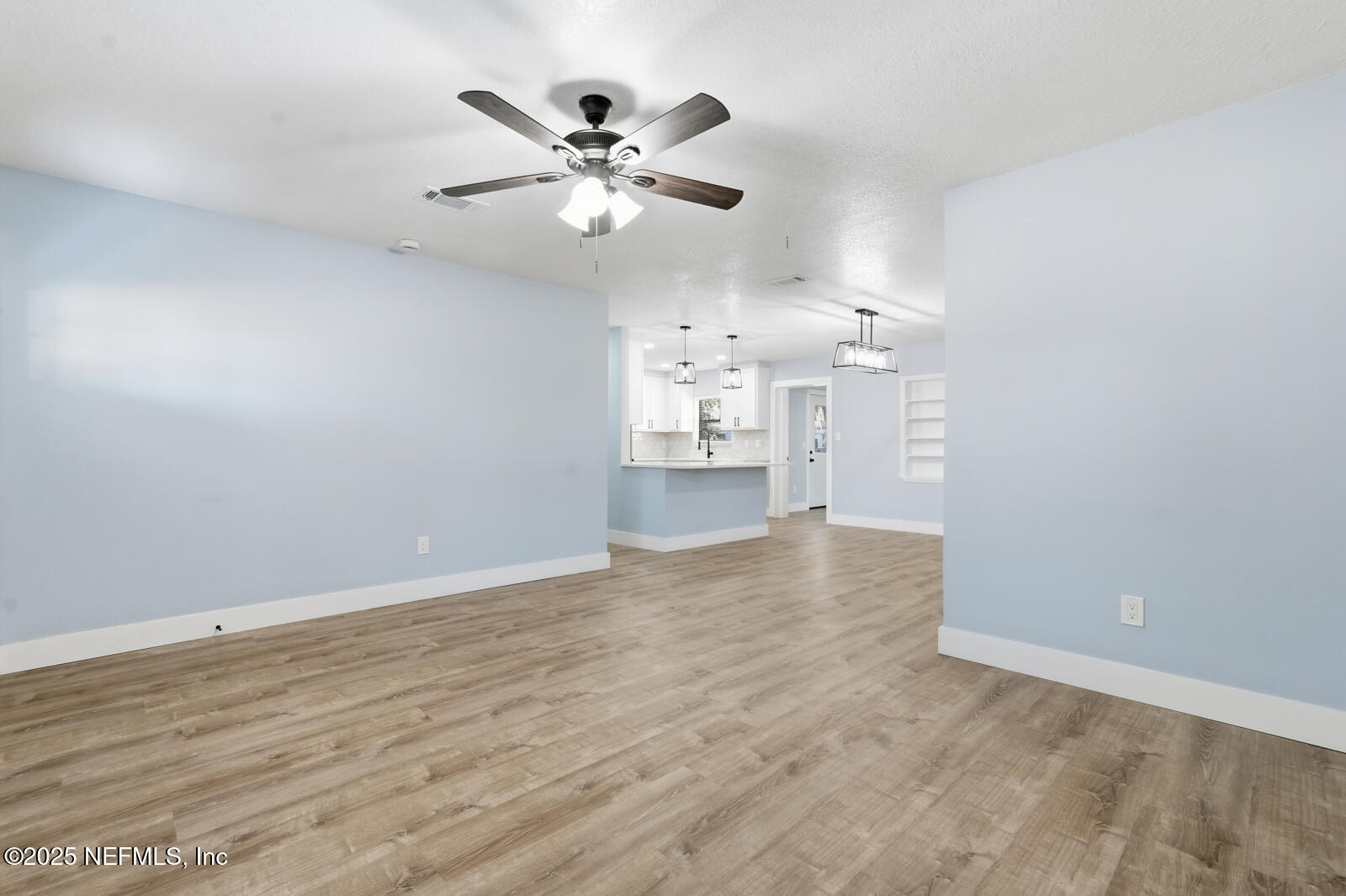 341 Alabama Avenue Palatka, FL 32177 - Photo 21 of 47 wooden floor in an empty room with a chandelier fan