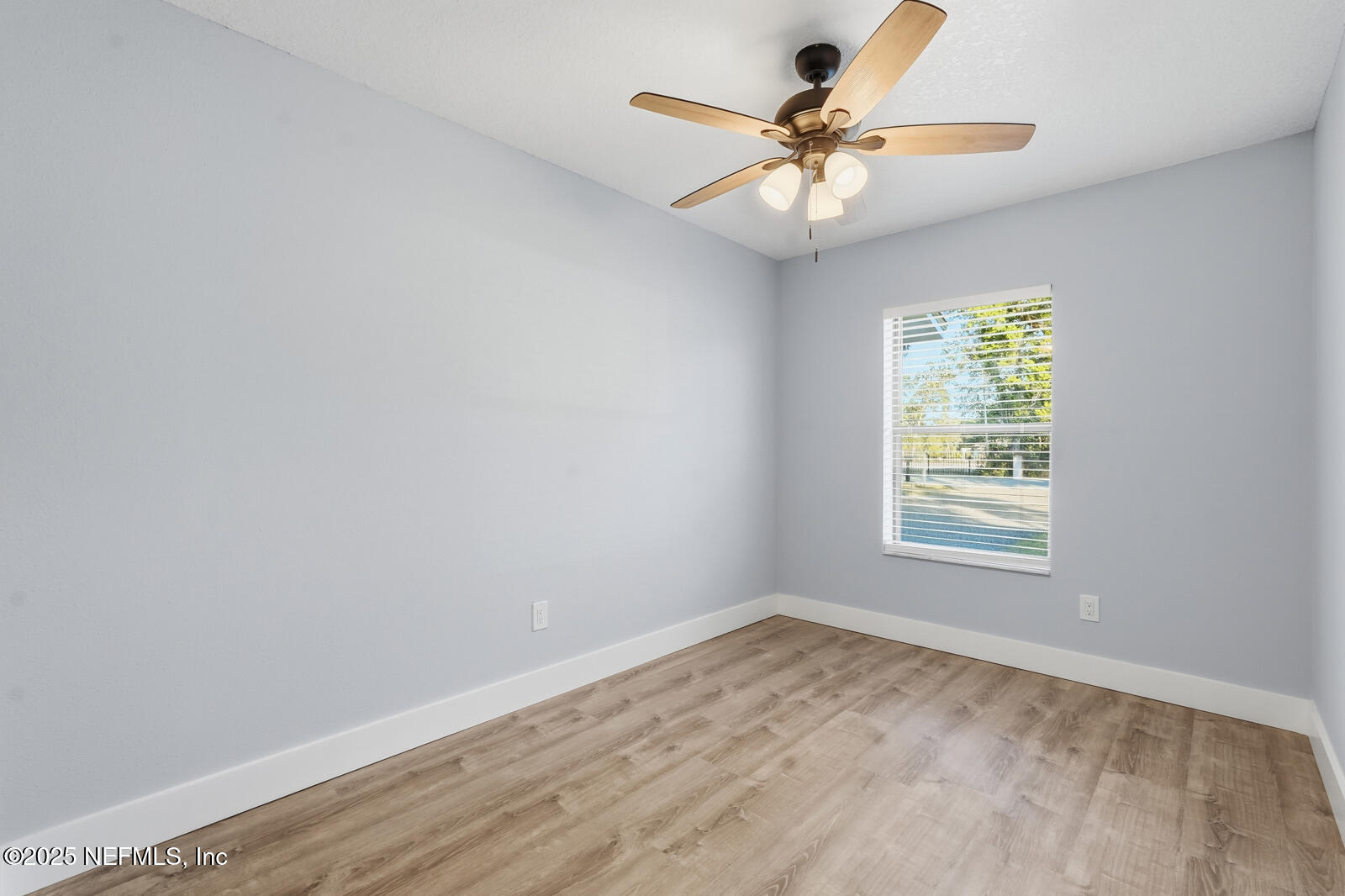 341 Alabama Avenue Palatka, FL 32177 - Photo 24 of 47 an empty room with a window and a fan
