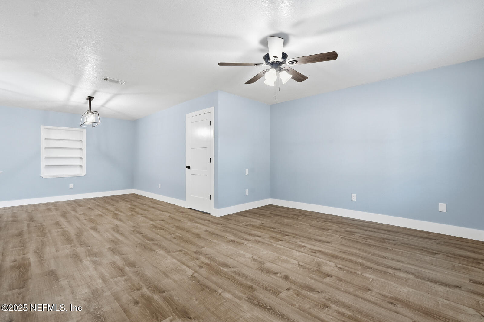 341 Alabama Avenue Palatka, FL 32177 - Photo 26 of 47 wooden floor in an empty room with a window