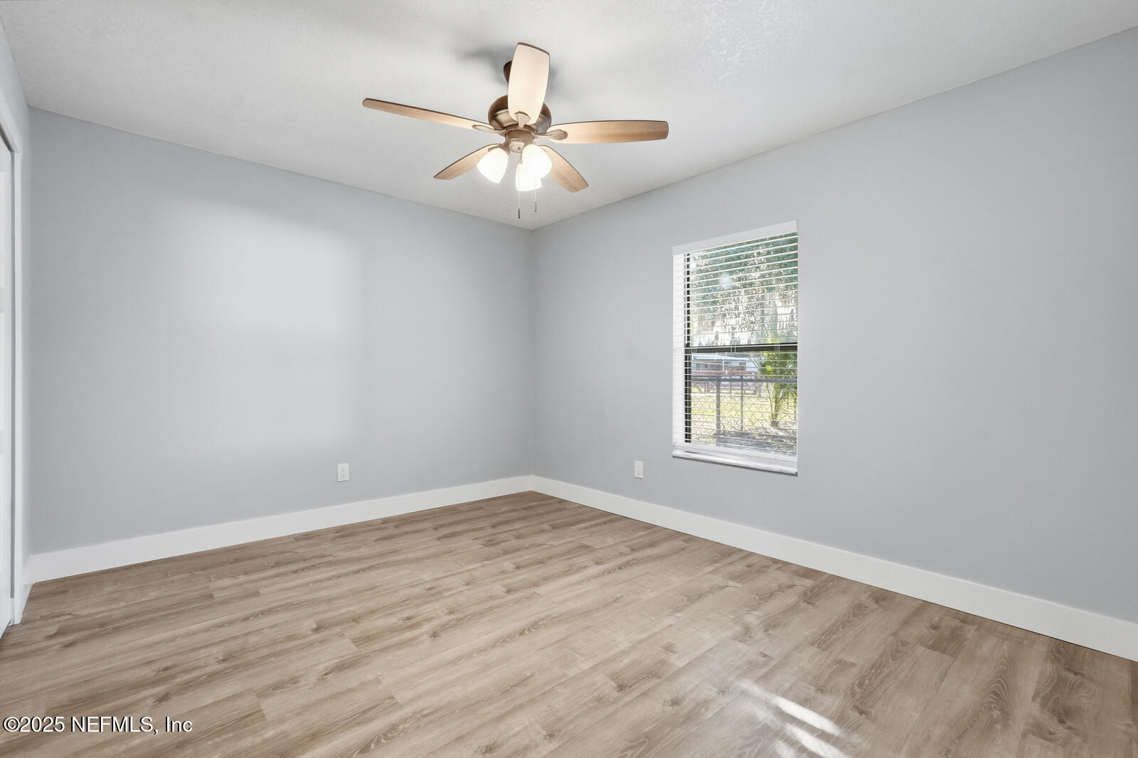341 Alabama Avenue Palatka, FL 32177 - Photo 33 of 47 an empty room with wooden floor fan and windows