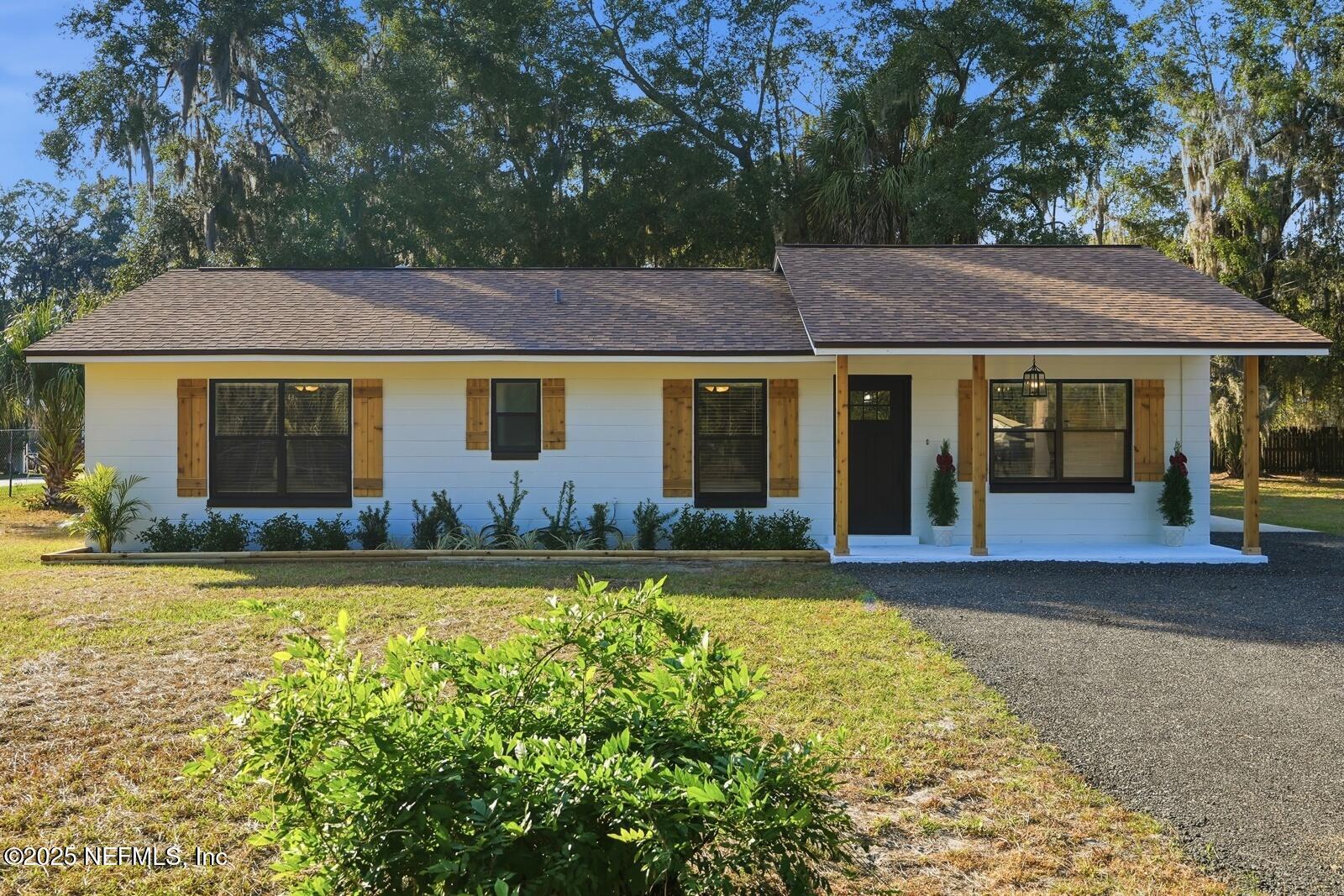 341 Alabama Avenue Palatka, FL 32177 - Photo 40 of 47 a front view of a house with a garden and yard