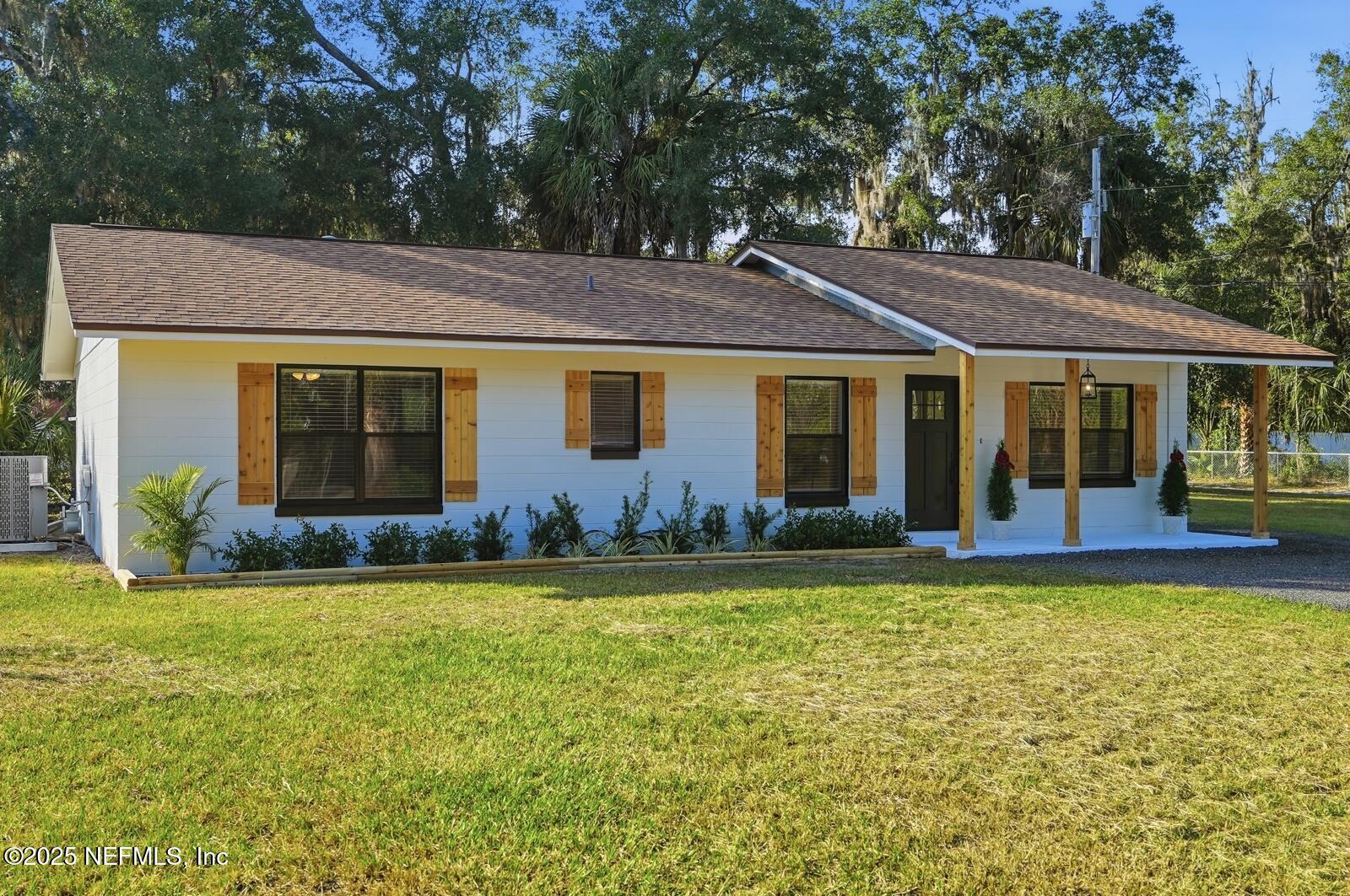 341 Alabama Avenue Palatka, FL 32177 - Photo 41 of 47 a view of a house with a yard potted plants and a table