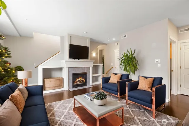 a living room with furniture a rug and a fireplace