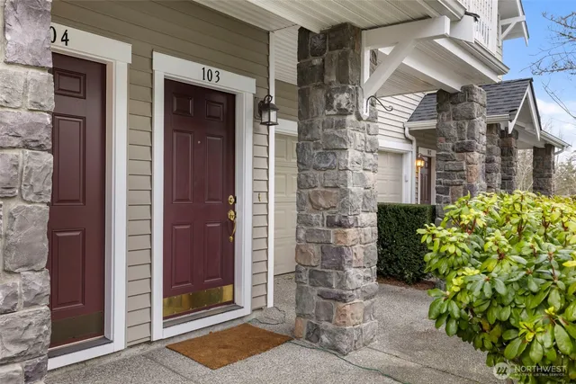a living room with furniture a fireplace and wooden floor