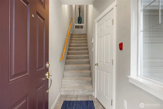 a view of entryway with wooden floor and stair