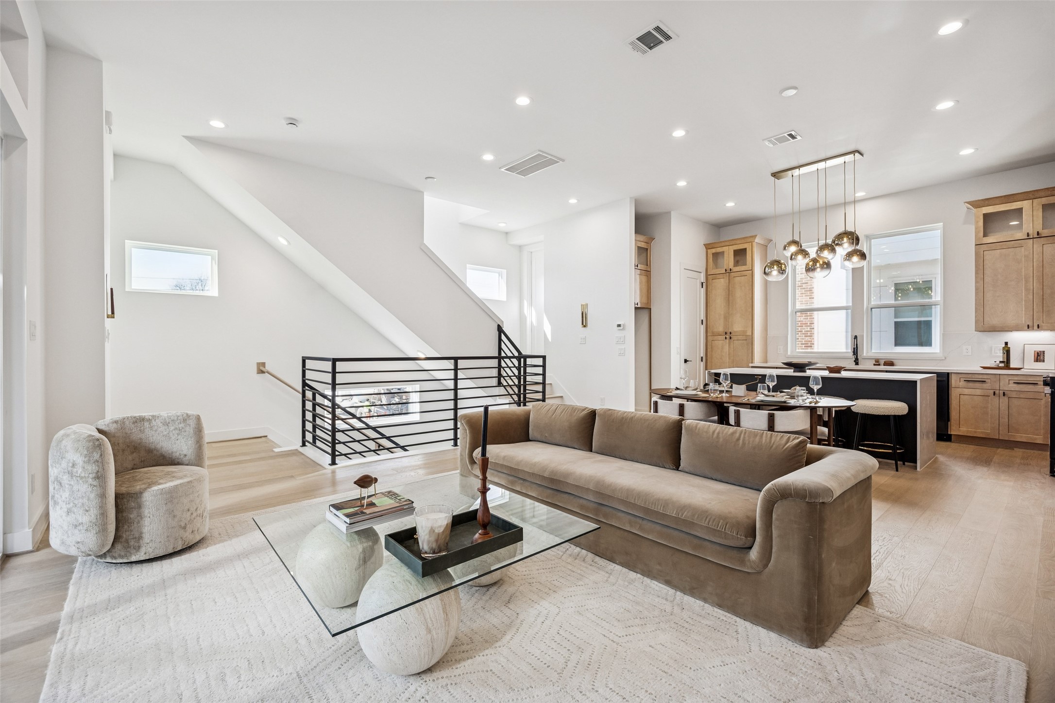 3008 Lamar Street Houston, TX 77003 - Photo 14 of 33 a living room with furniture kitchen view and a chandelier