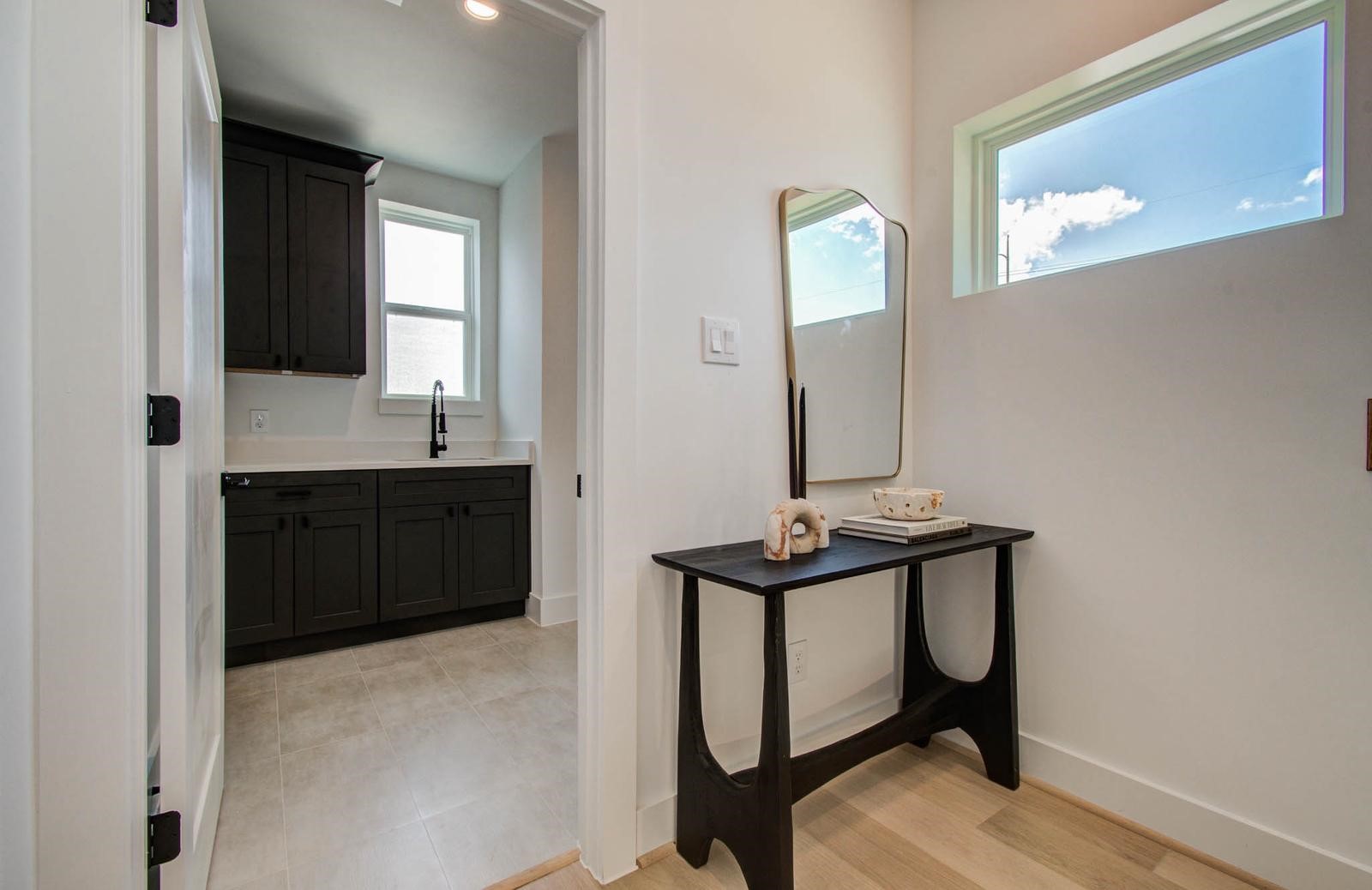 3008 Lamar Street Houston, TX 77003 - Photo 29 of 33 a bathroom with a sink a light fixture and a mirror