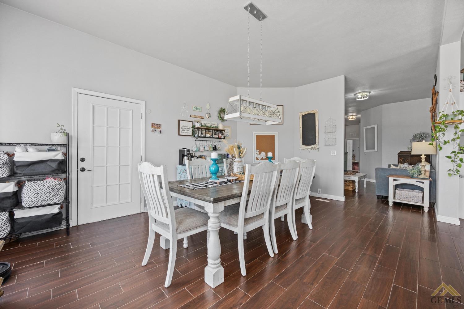 Undisclosed Address Bakersfield, CA 93308 - Photo 13 of 39 a view of a dining room with furniture and wooden floor
