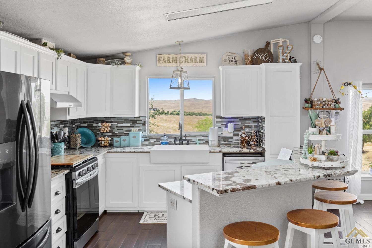 Undisclosed Address Bakersfield, CA 93308 - Photo 18 of 39 a kitchen with a sink refrigerator and cabinets