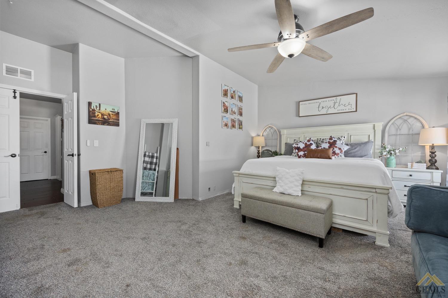 Undisclosed Address Bakersfield, CA 93308 - Photo 24 of 39 a bedroom with a white bed and ceiling fan