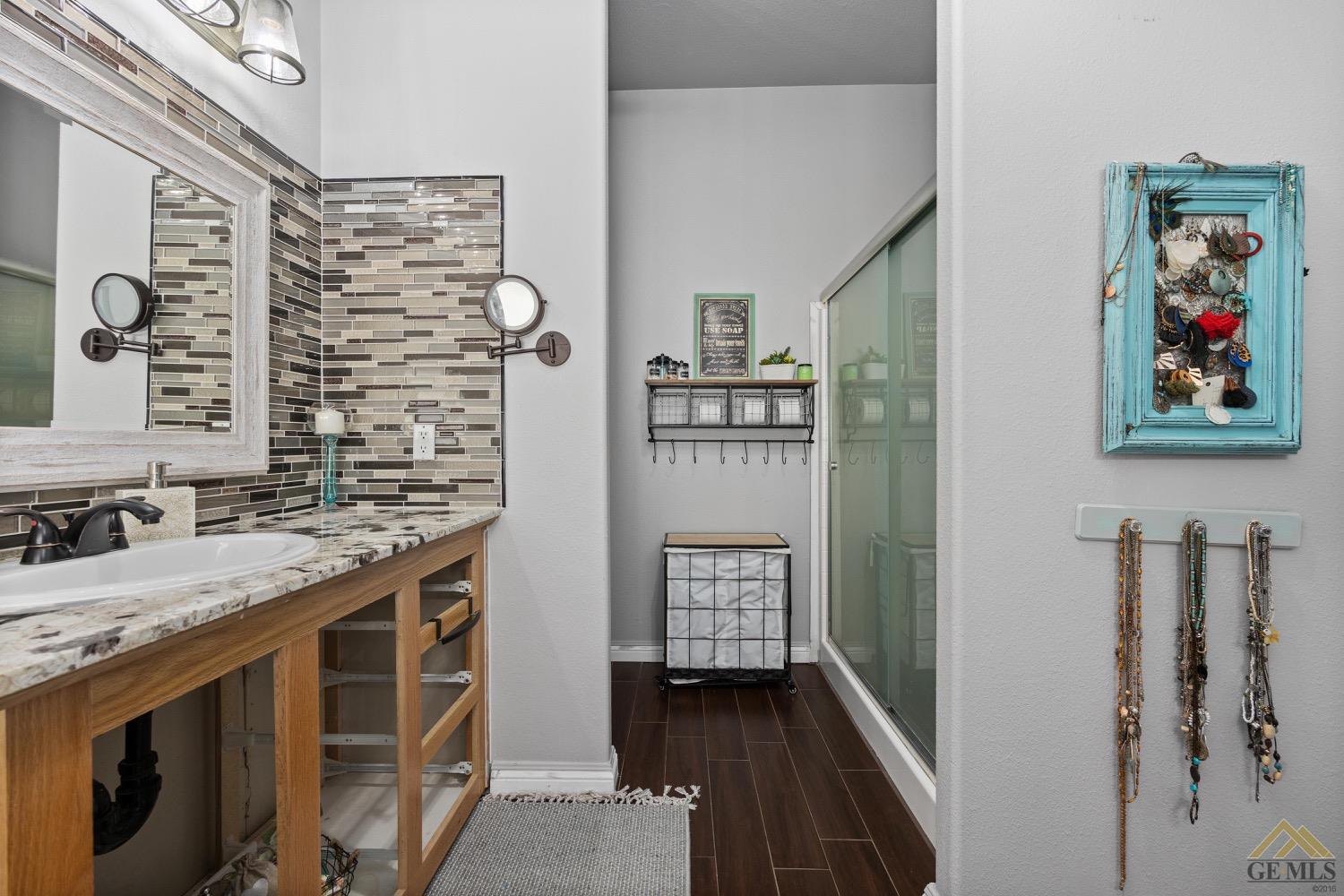 Undisclosed Address Bakersfield, CA 93308 - Photo 29 of 39 a bathroom with a granite countertop sink a toilet and shower