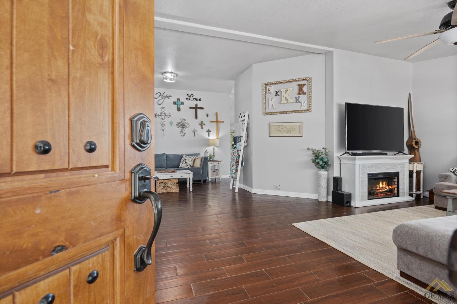 Undisclosed Address Bakersfield, CA 93308 - Photo 7 of 39 a living room with furniture and a flat screen tv