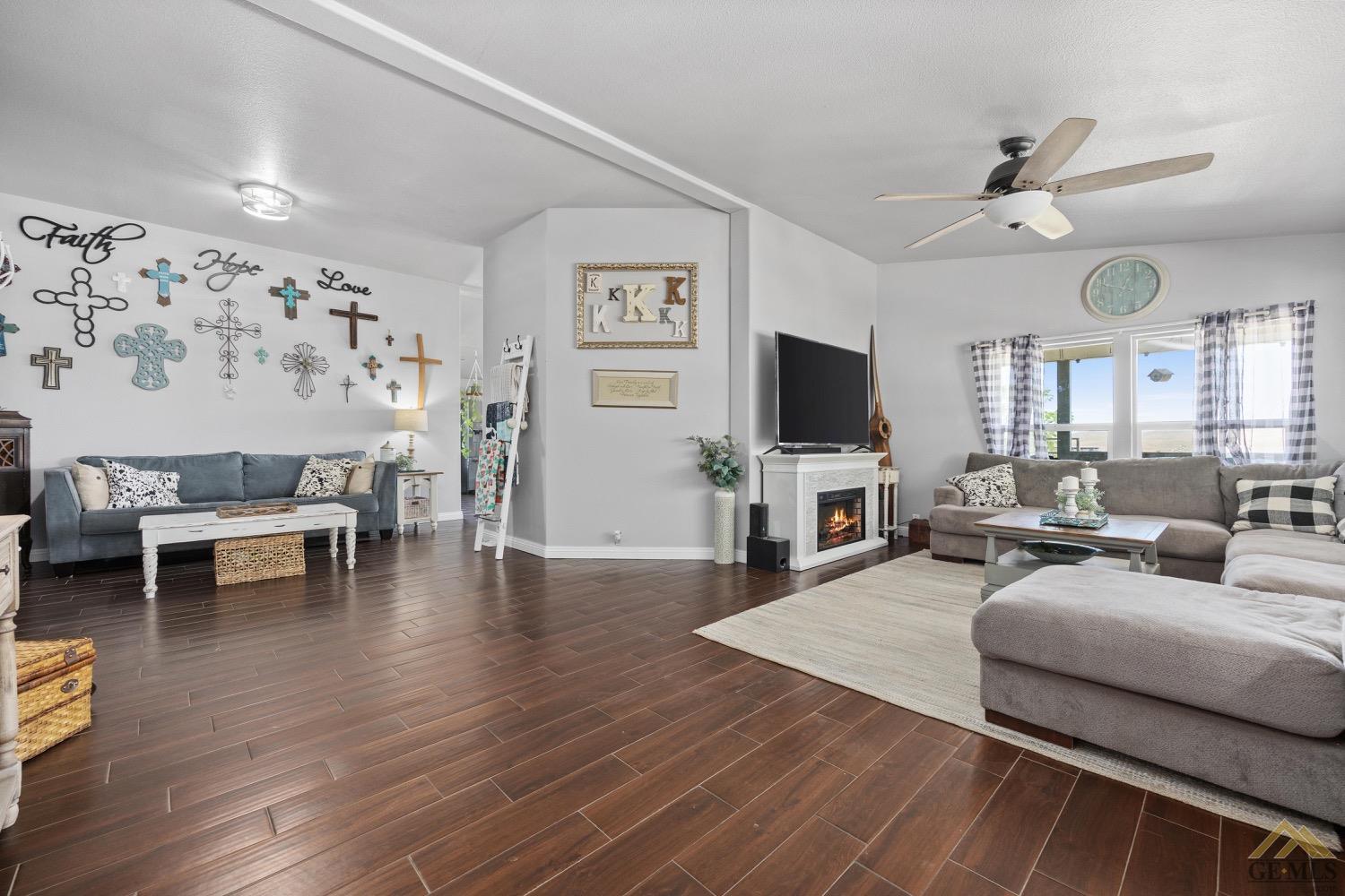 Undisclosed Address Bakersfield, CA 93308 - Photo 8 of 39 a living room with furniture and a flat screen tv