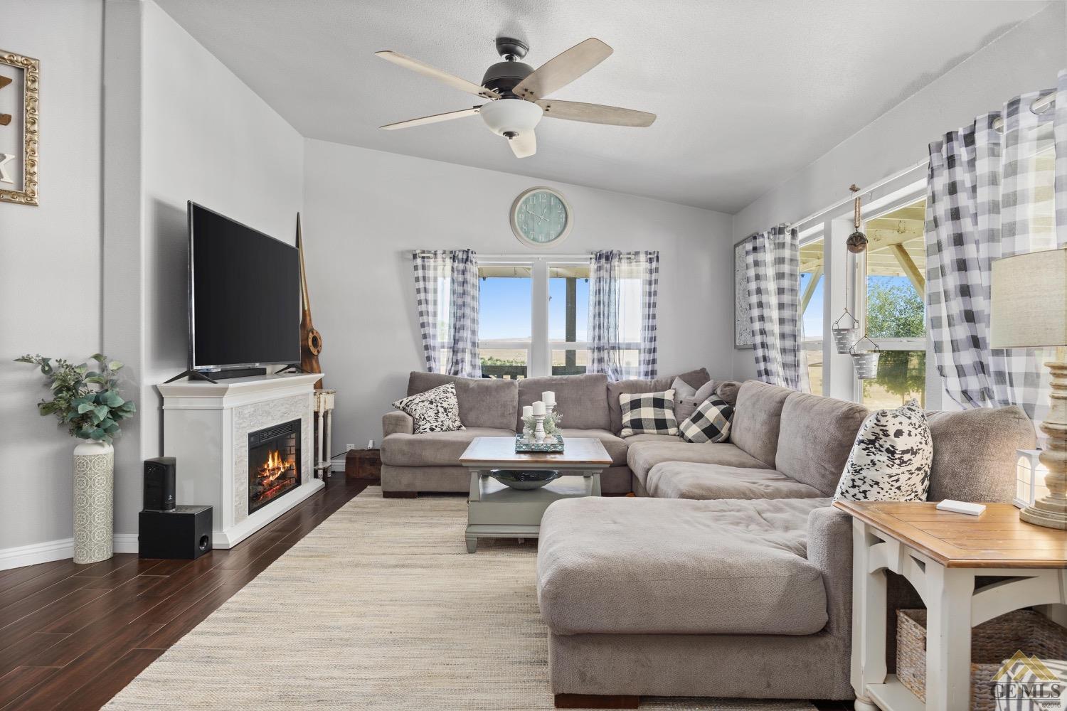 Undisclosed Address Bakersfield, CA 93308 - Photo 10 of 39 a living room with furniture a fireplace and a flat screen tv