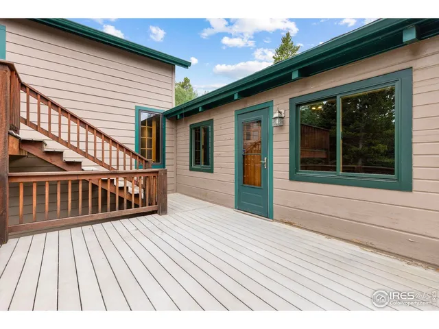 a view of deck with a barbeque and wooden stairs