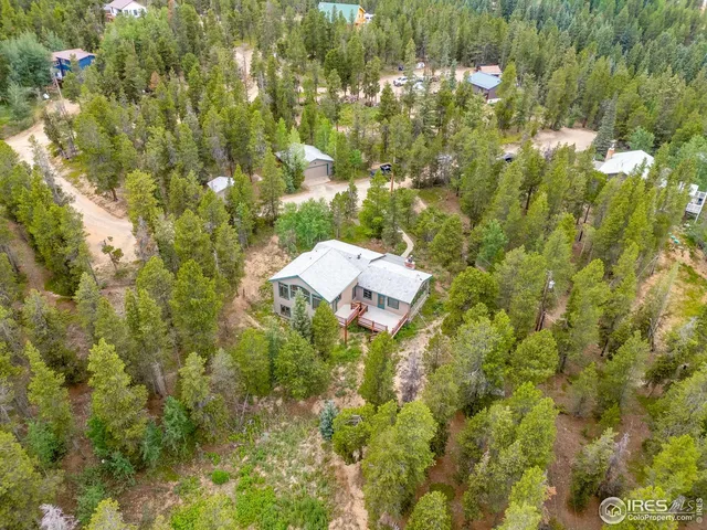 a aerial view of residential house with parking and yard