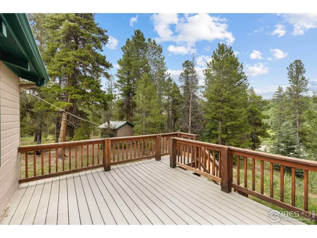 a view of balcony with wooden floor and fence