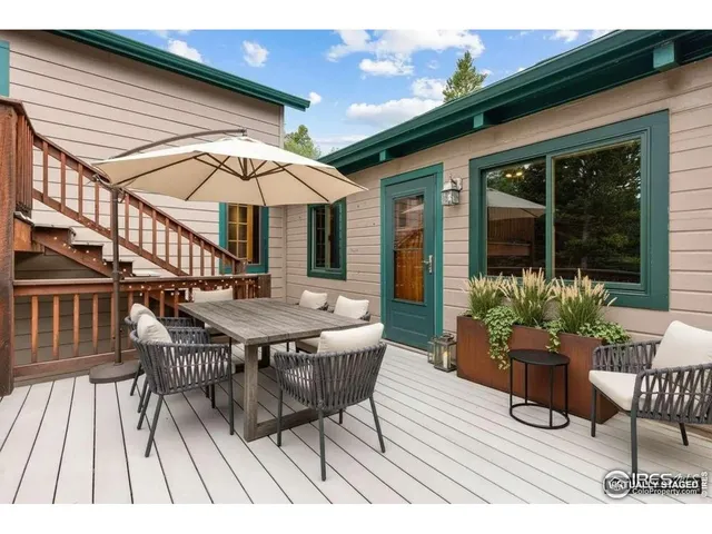 a view of a patio with a table and chairs