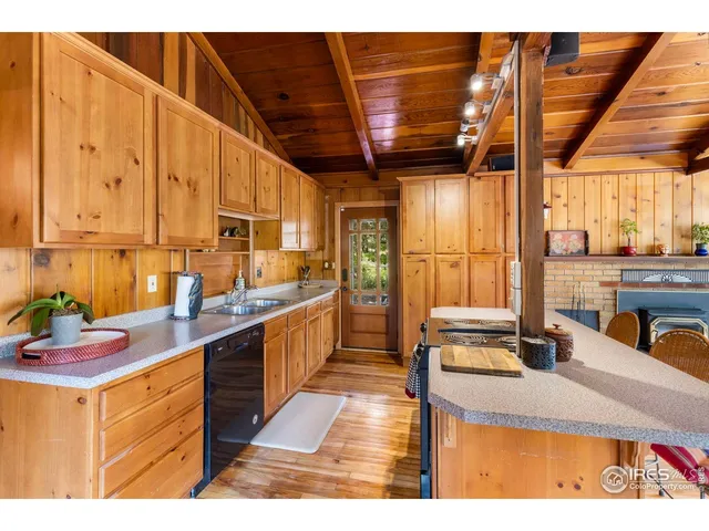 a kitchen with kitchen island granite countertop a sink counter top space and cabinets