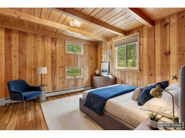 a bedroom with a bed and a chair