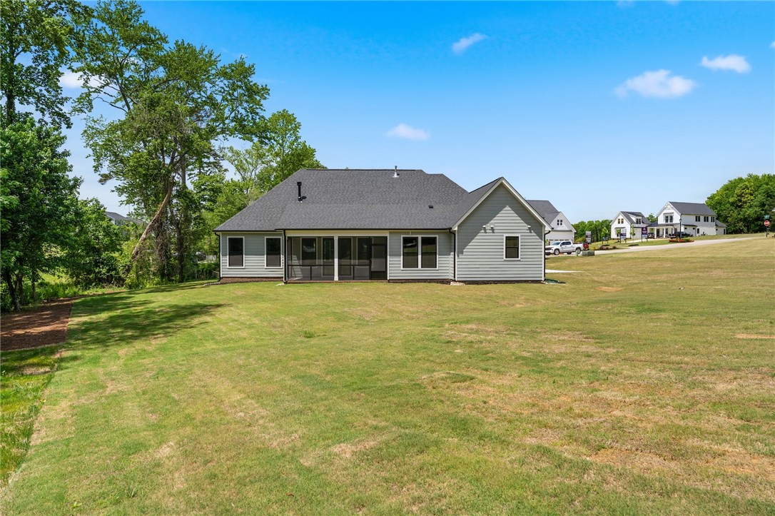 203 Timothy Court Anderson, SC 29621 - Photo 23 of 40 A well-maintained lawn extends from this residence with a screened porch, offering seamless indoor-outdoor living.