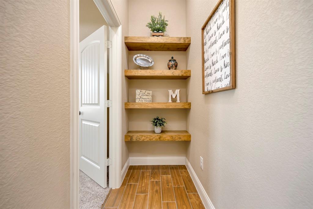 3224 North Cardinal Road Azle, TX 76020 - Photo 19 of 40 Recessed wall shelving featuring four wood-finish floating shelves