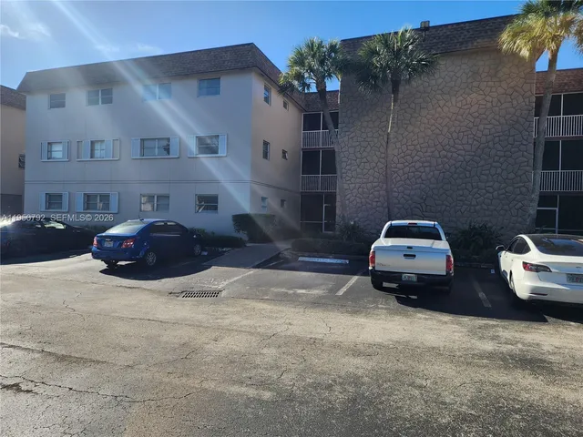 a view of a cars parked in front of a house
