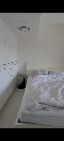 a bedroom with a bed and a view of cupboard