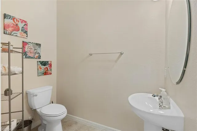 a white toilet sitting next to a bathroom sink