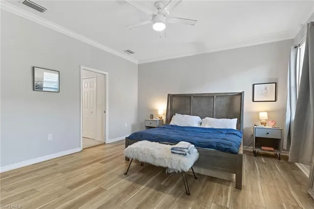 a bedroom with a bed and wooden floor