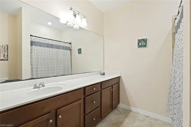 a bathroom with a double vanity sink and a mirror