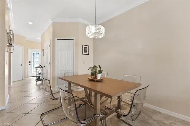 a view of a dining room with furniture and chandelier