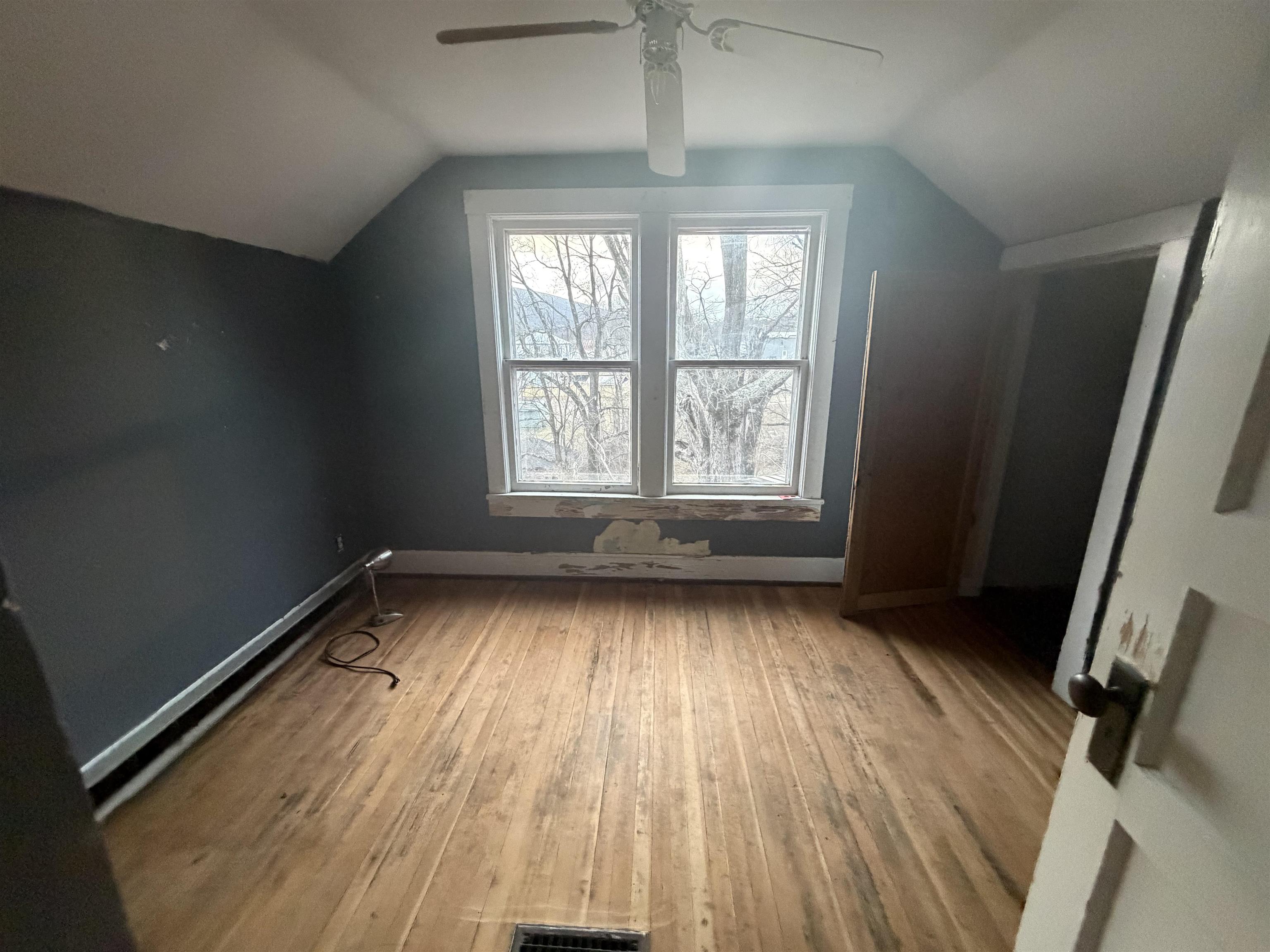 39 Church Hl Road Goshen, VA 24439 - Photo 9 of 27 a view of an empty room with wooden floor and a window