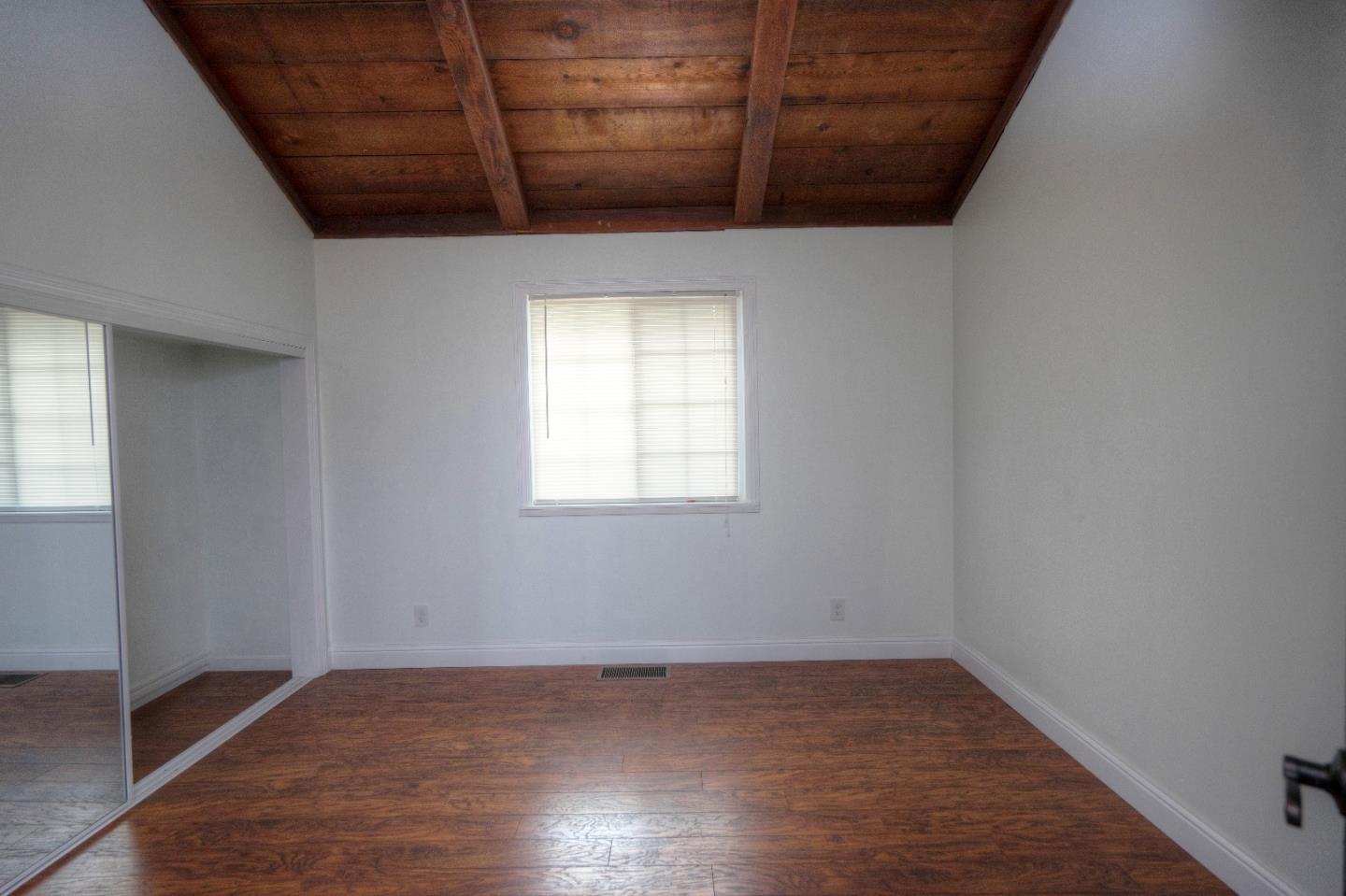 197 Ramona Avenue Pacifica, CA 94044 - Photo 14 of 26 a view of a room with wooden floor and window
