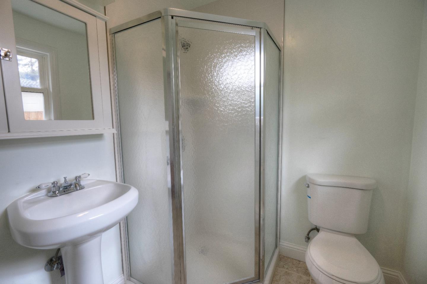 197 Ramona Avenue Pacifica, CA 94044 - Photo 18 of 26 a bathroom with a sink toilet and shower