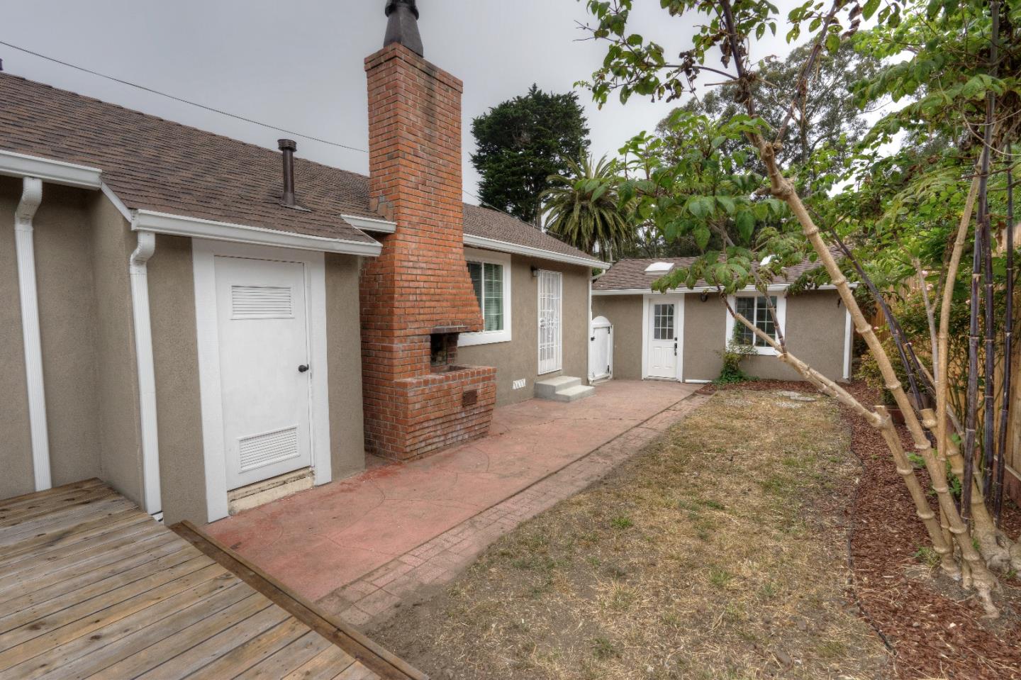 197 Ramona Avenue Pacifica, CA 94044 - Photo 4 of 26 a view of a house with a backyard and a tree