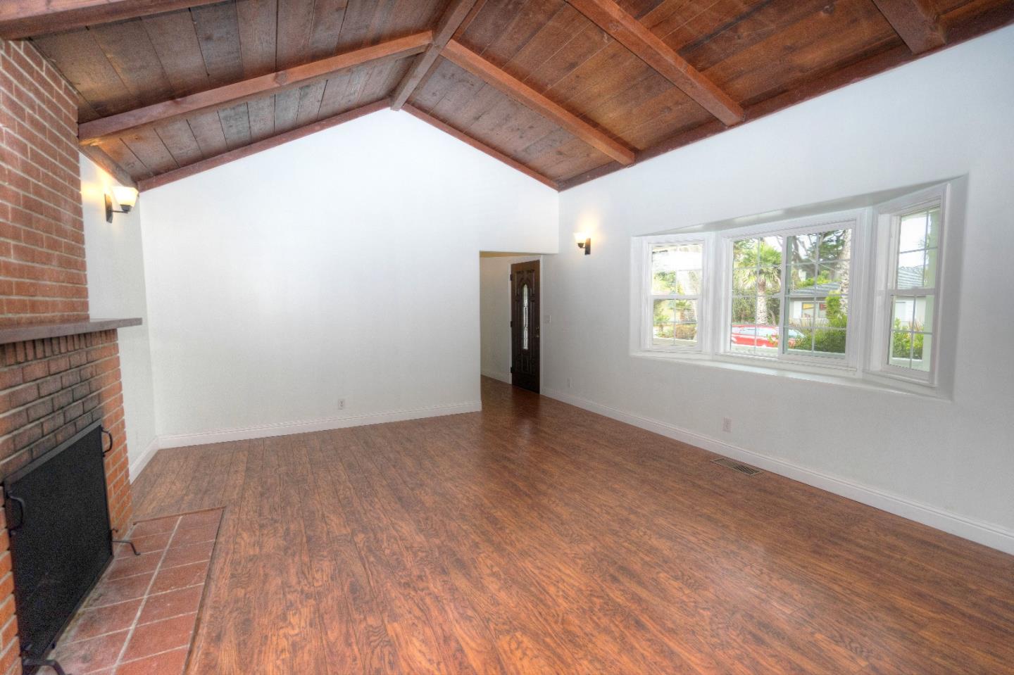 197 Ramona Avenue Pacifica, CA 94044 - Photo 7 of 26 a view of an empty room with wooden floor and a window