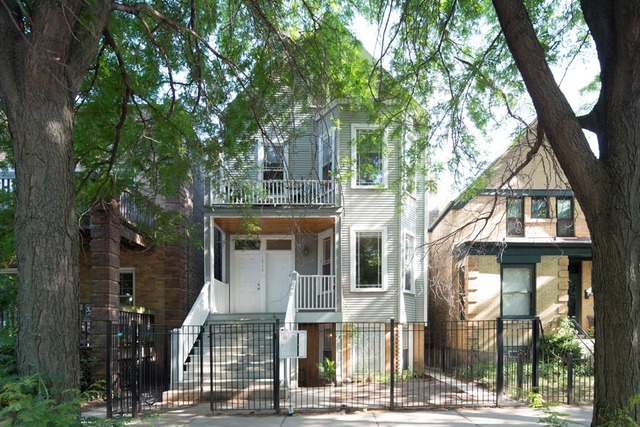 1314 West Roscoe Street, Unit 1 Chicago, IL 60657 - Photo 1 of 1 a front view of a house with a tree