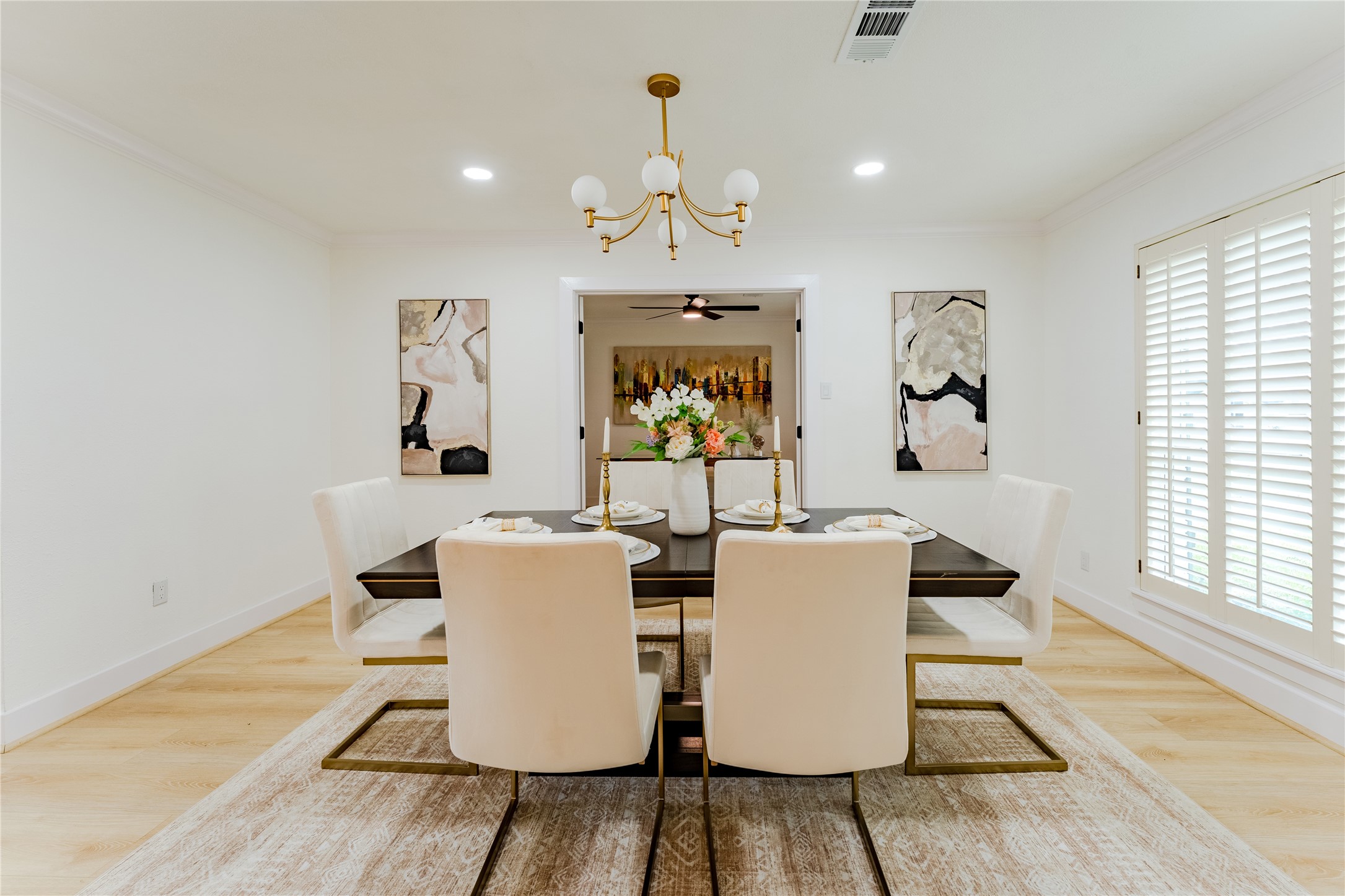 6027 Valkeith Drive Houston, TX 77096 - Photo 9 of 31 a dining room with wooden floor a chandelier a glass table and windows