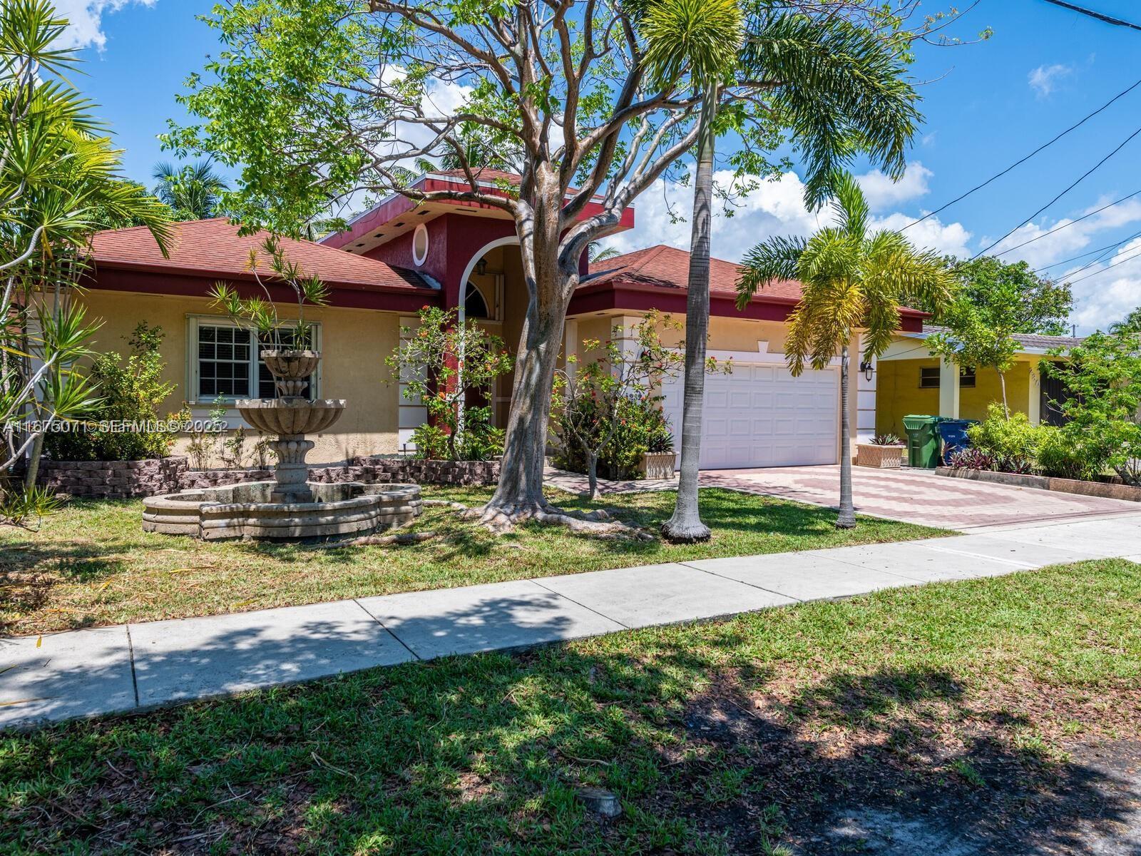 232 Southwest 7th Avenue Hallandale Beach, FL 33009 - Photo 11 of 48 a view of a house with swimming pool and a yard