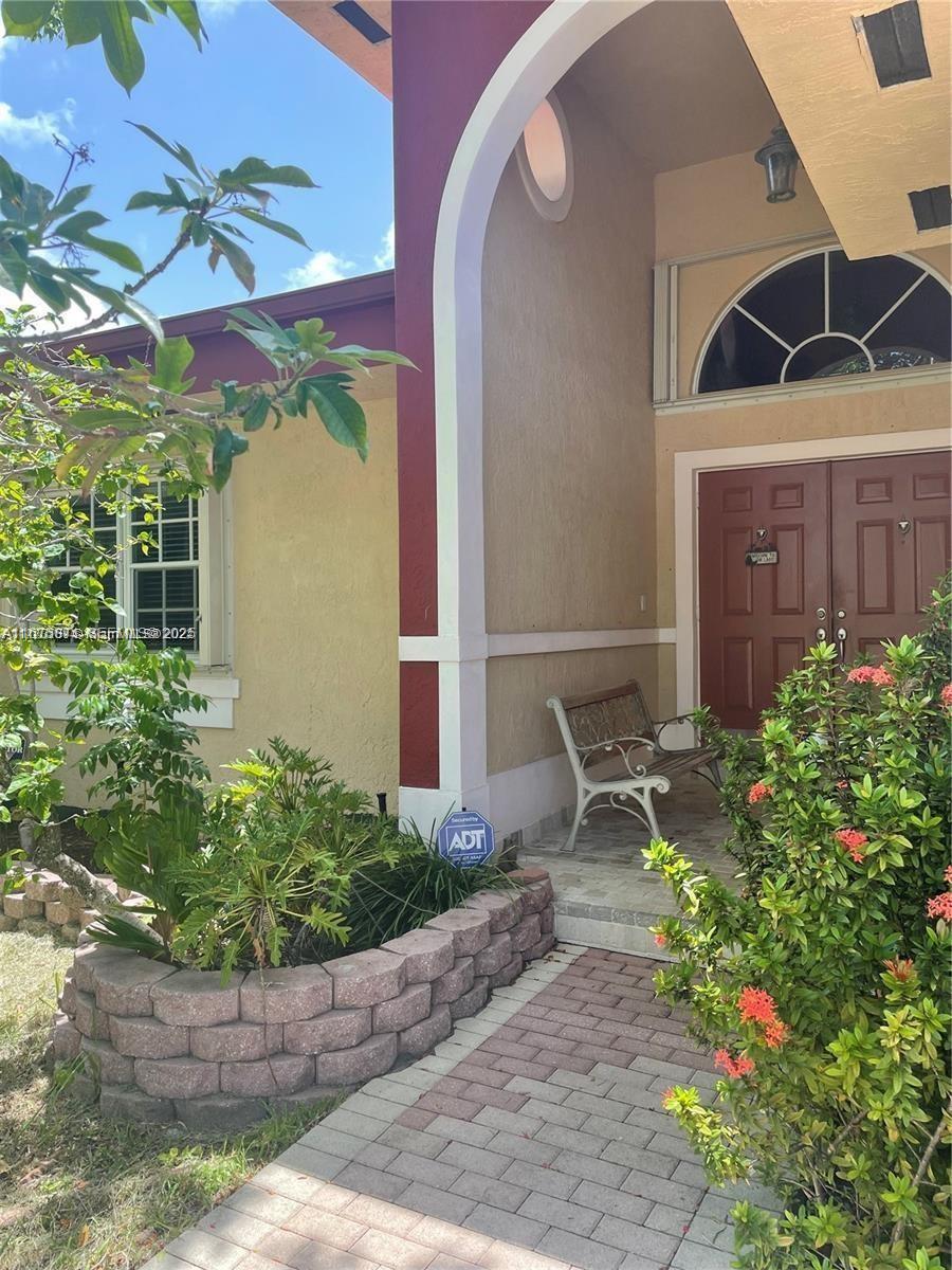 232 Southwest 7th Avenue Hallandale Beach, FL 33009 - Photo 12 of 48 a front view of a house with a yard