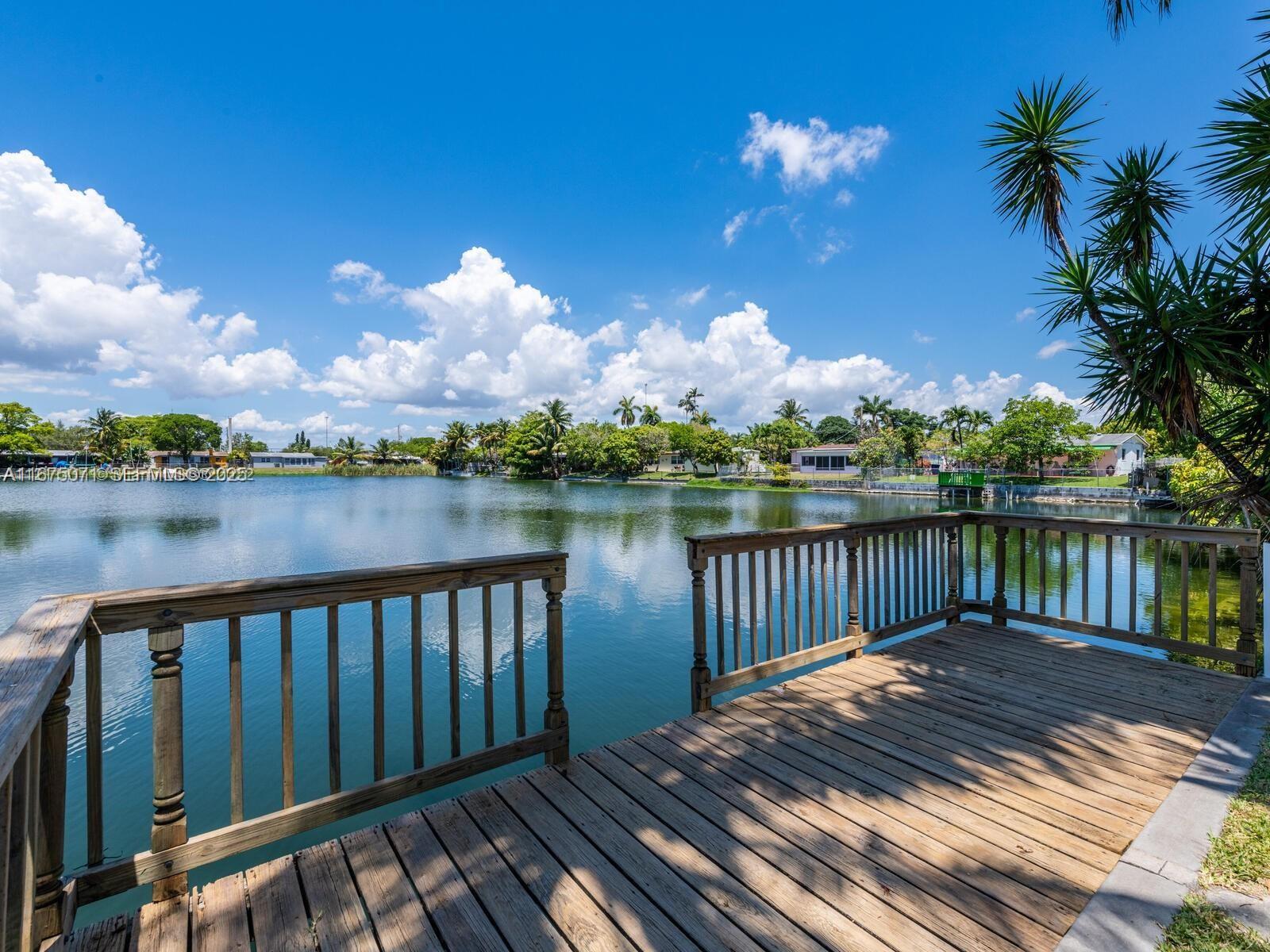 232 Southwest 7th Avenue Hallandale Beach, FL 33009 - Photo 14 of 48 a balcony with wooden floor and lake view