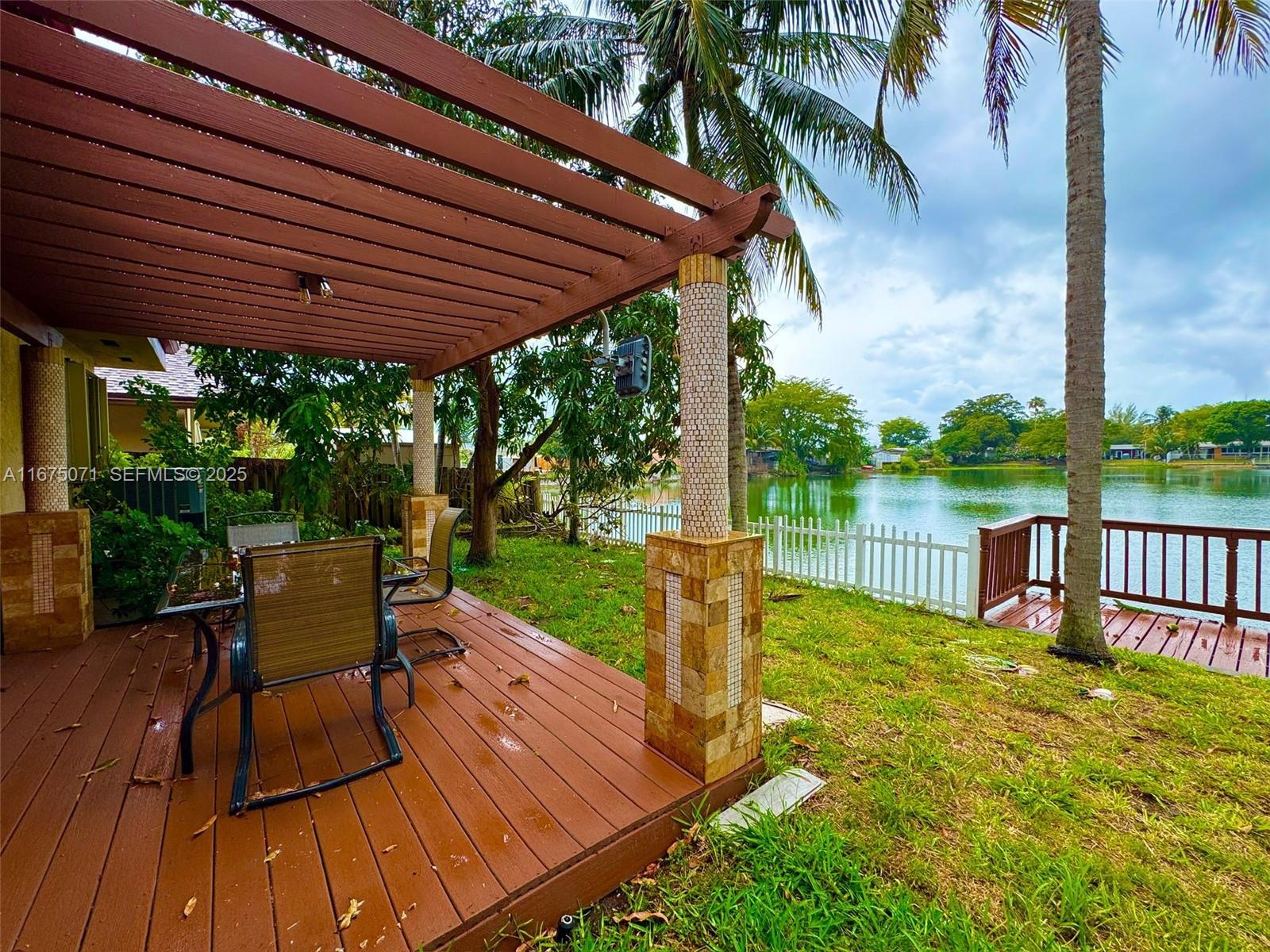 232 Southwest 7th Avenue Hallandale Beach, FL 33009 - Photo 16 of 48 a view of a patio with a table chairs and a patio