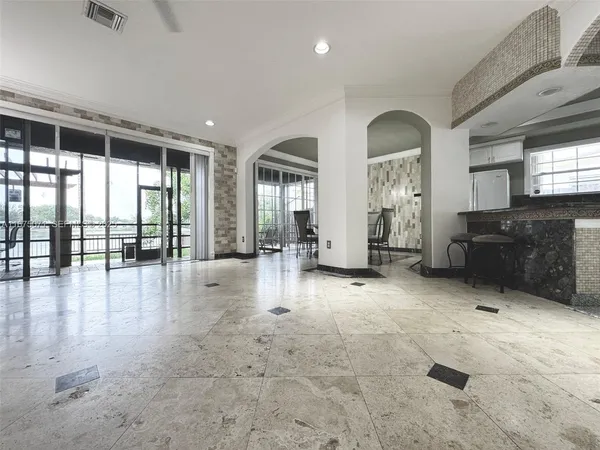 an empty room with fireplace and windows