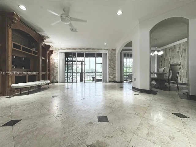 an empty room with entrance and windows