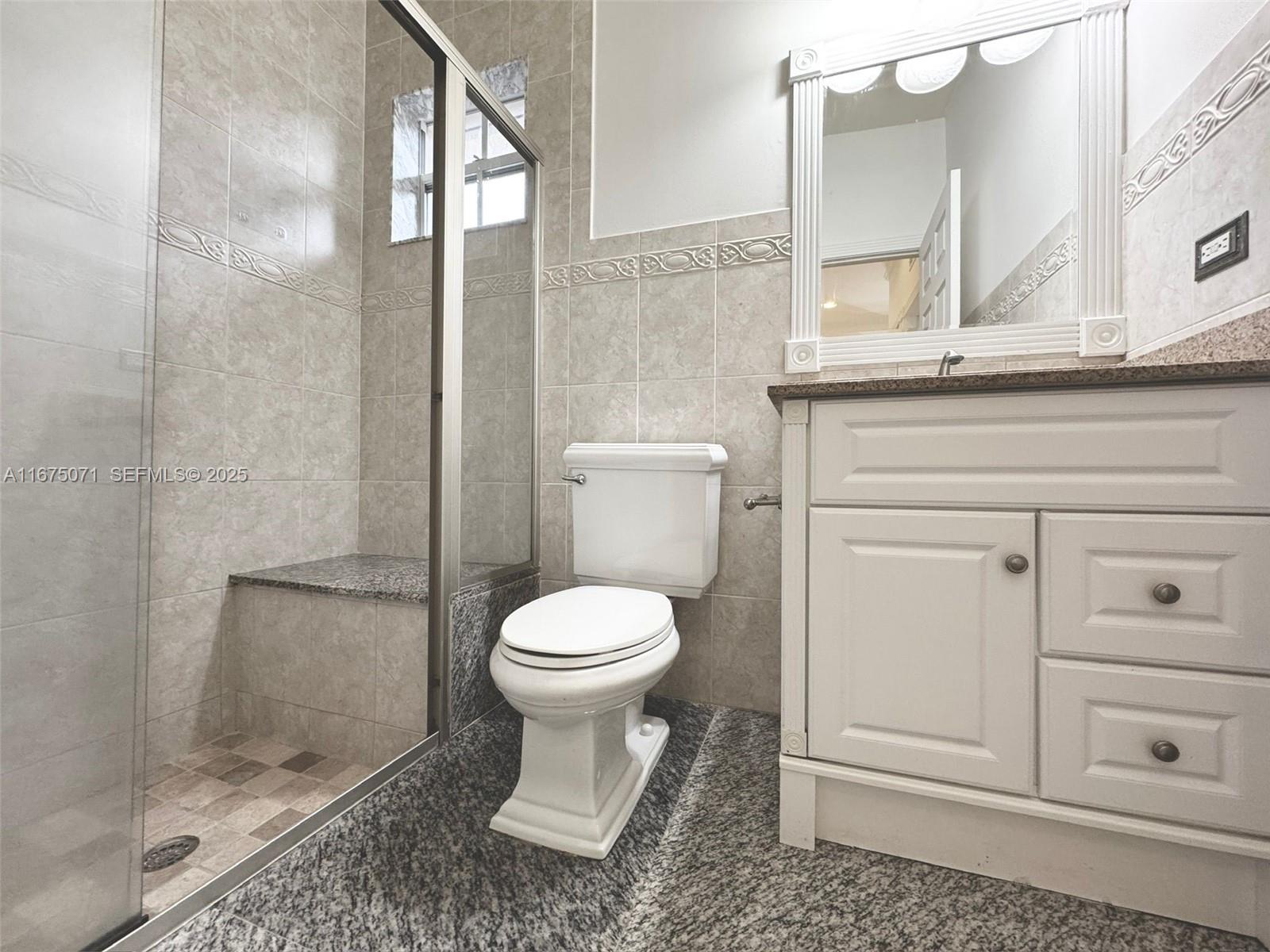 232 Southwest 7th Avenue Hallandale Beach, FL 33009 - Photo 37 of 48 a bathroom with a toilet a sink and a mirror