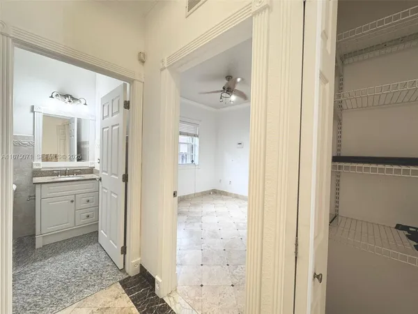 a bathroom with a granite countertop sink mirror and a shower