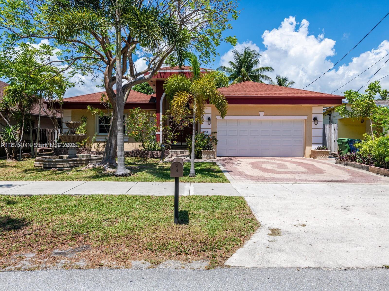 232 Southwest 7th Avenue Hallandale Beach, FL 33009 - Photo 6 of 48 a front view of a house with garden